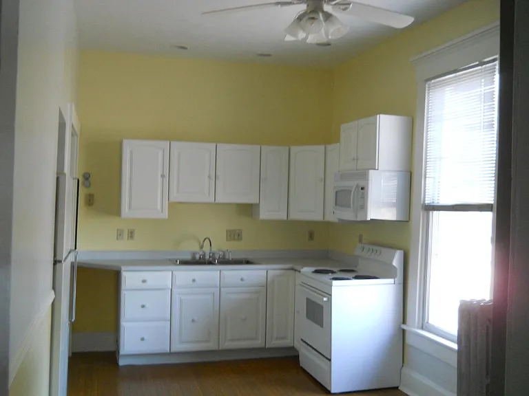 Built-in Microwave and Ceiling Fan, with Electric Stove at South End of the 'eat-in-kitchen'. Lots of natural light from huge west-faced window.