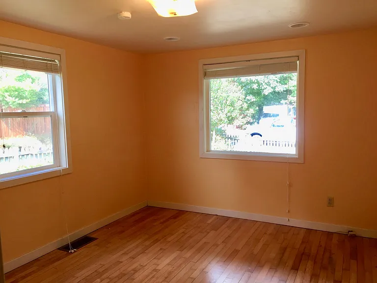 Bedroom #1, left window looks out side of house