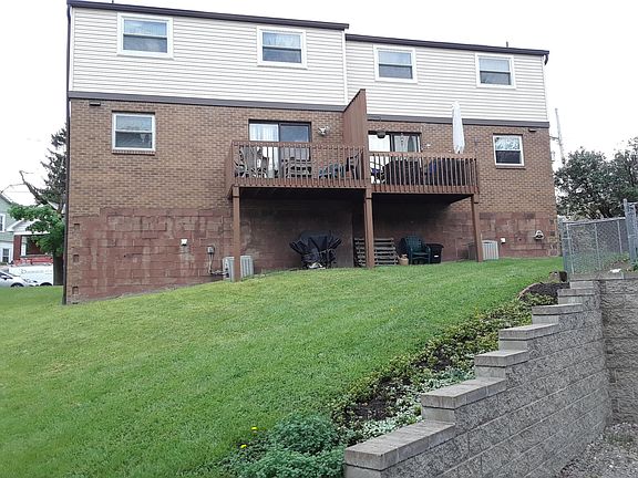 Back of home with private deck