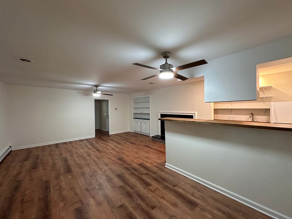 The living/dining area looking toward the door that leads to the bathroom and bedroom.