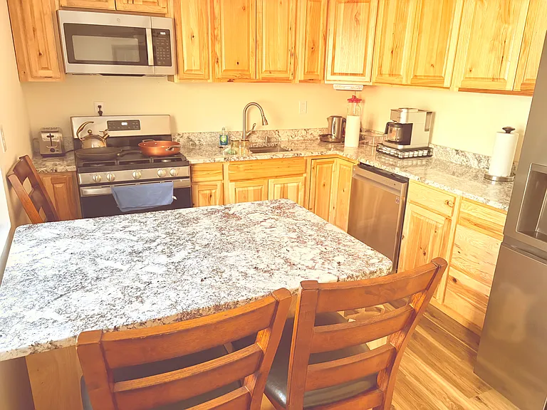 The kitchen is stocked and ready for cooking, and it's the perfect spot to enjoy your morning coffee while watching birds and forest wildlife right outside the window.