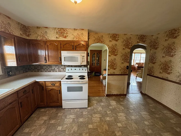 Kitchen, looking into the dining room and living room, there will be a frig that goes between the two openings.