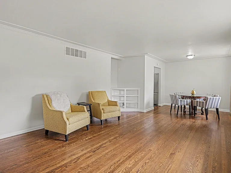 Main level living/dining room with fireplace and built in bookshelf.