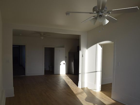 View of the entrance, bathroom, dining area and bedroom door from the living room.