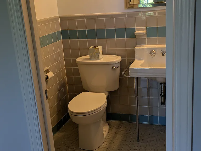 Master bath, original tile, sink and shower.