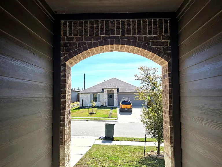 Covered front entryway offering a welcoming and shaded entrance.