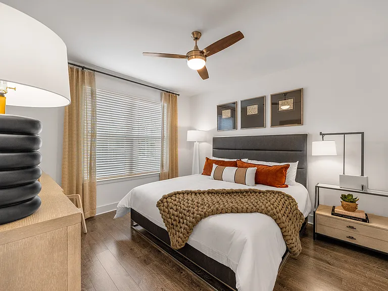 Elegant bedroom featuring a modern design with a cozy bed, stylish accessories, and warm lighting.