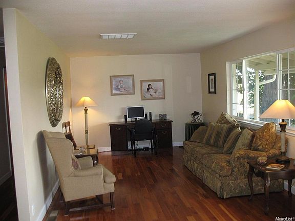 Wood flooring and beautiful views toward the mountains add to the appeal of this living room.