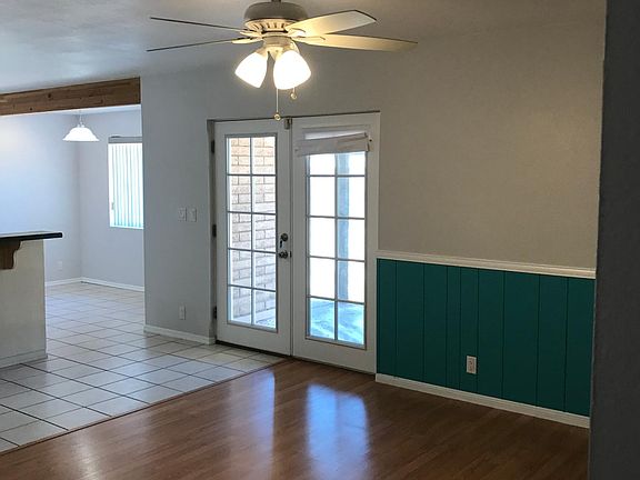 Large family room with direct access to kitchen area. One of two separate living areas. French doors lead to covered patio in the back yard.