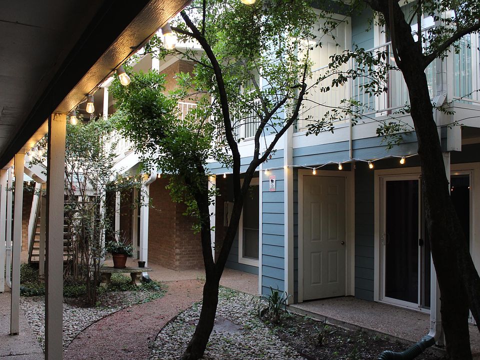 Market lights welcome visitors to the tree-shaded courtyard