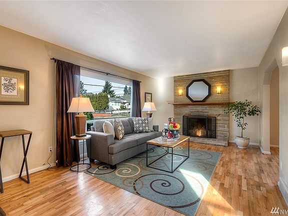 This pleasant light filled space is beautifully accented by the refinished original solid oak hardwood floors and cozy wood burning fireplace.