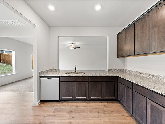 The kitchen has sprawling granite countertops.