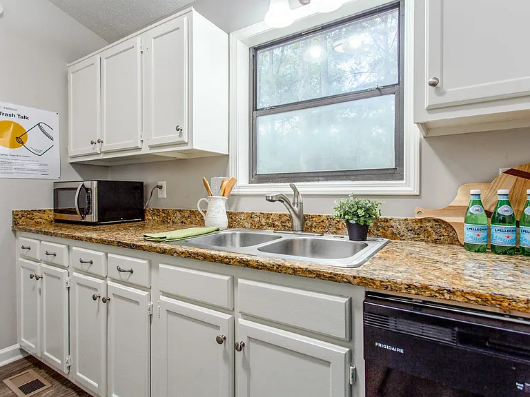 Kitchen with microwave, dishwasher, gas stove/oven and refrigerator/freezer.