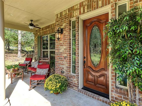 This beautiful solid wood leaded glass door has additional side lights on each side for a welcoming entry. Notice the extra large seating area on the left where you can comfortably enjoy stunning sunsets.