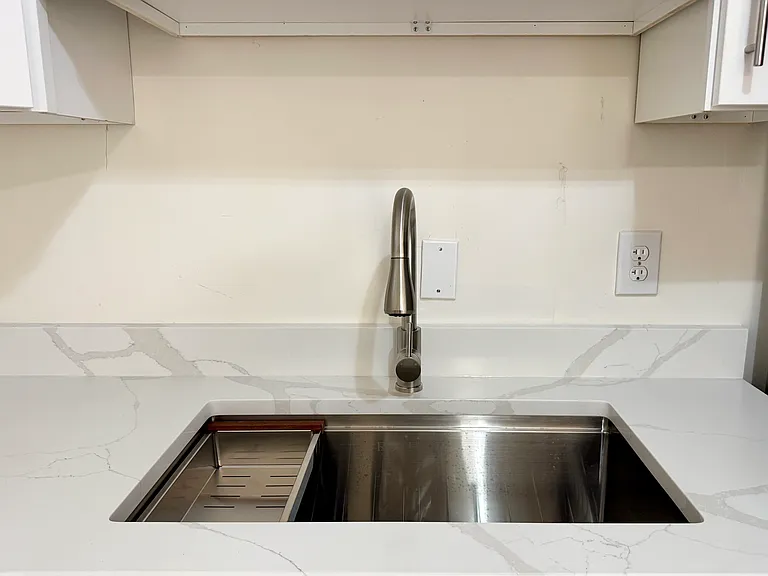 Beautiful quartz countertops and new deep stainless steel sink.