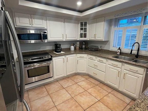 several cabinets for storage, stainless appliances.