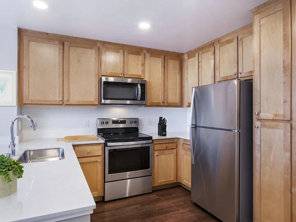 Photo 2 of 69 - Avalon San Bruno - San Bruno, CA Renovated Package II Kitchen with stainless steel appliances and hard surface flooring - Avalon San Bruno