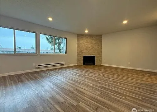 All new paint and flooring with cozy fireplace