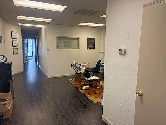 View of private treatment rooms, rear entry and open area.