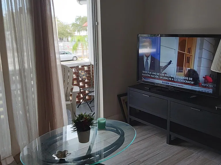 Livingroom and sliding door to the balcony. 52 inches TV