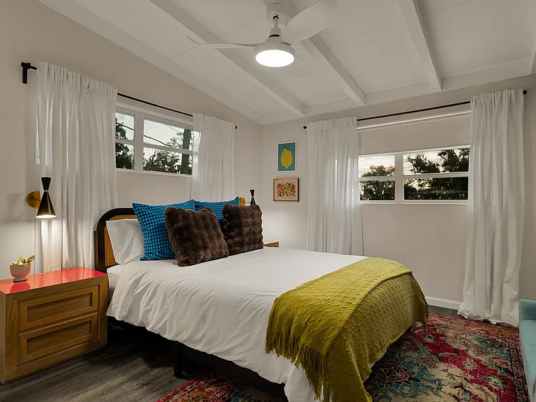 Bedroom two has a comfortable Queen-Size bed with cotton sheets, duvet, extra pillows and blankets, full length mirror, lighted vanity mirror & chair and closet. Other features include blackout blinds, curtains, and ceiling fan with light.