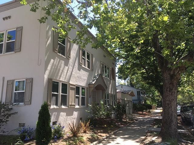 The advertised unit is in this triplex at the corner of 24th and W Streets. Insulated walls and ceilings and double-paned windows, along with the mature trees, keep the building cool and quiet.