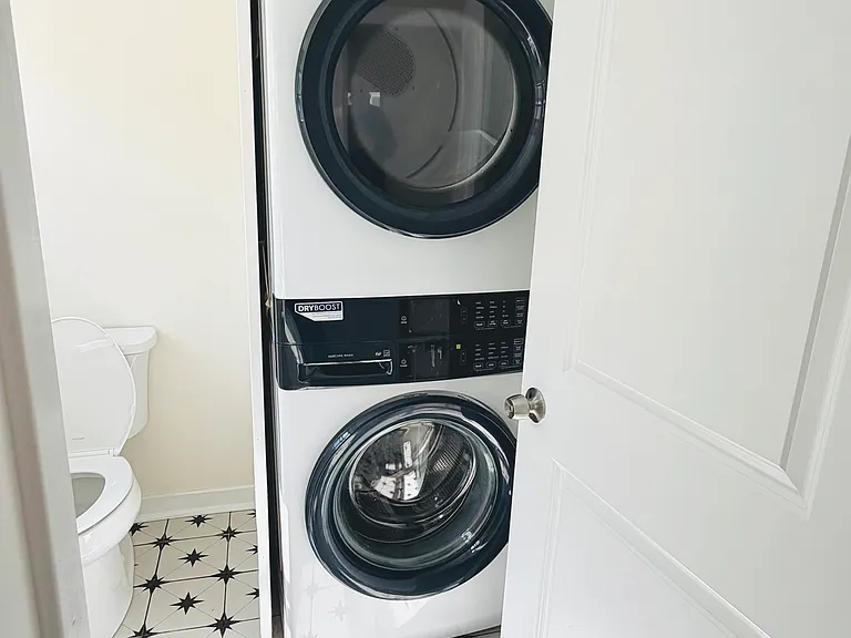 Electrolux stacked front-load washer and dryer with DryBoost technology _ no laundromat trips needed.