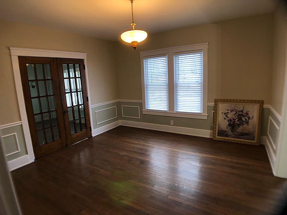 This is the dining room viewed from the kitchen through the swinging door. Most doors are original from 1923. The light looks or