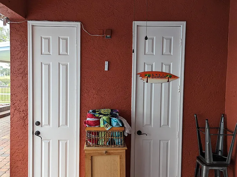 Toy closet (left) holds inflatables and fishing supplies you are welcome to use during your stay. Restroom (right) is a half-bath providing for sink and toilet access without having to enter the home wet and dripping.