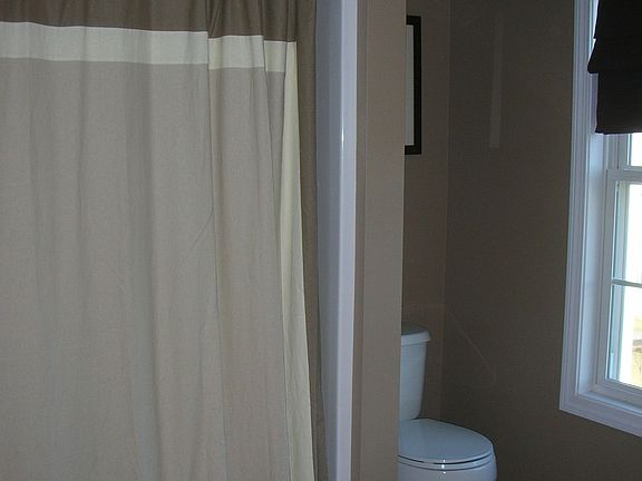 master bath room with full tub and linen closet