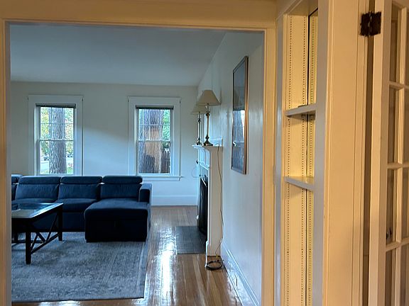 Front hallway from dining room to living room with French doors to inner hallway on the right.