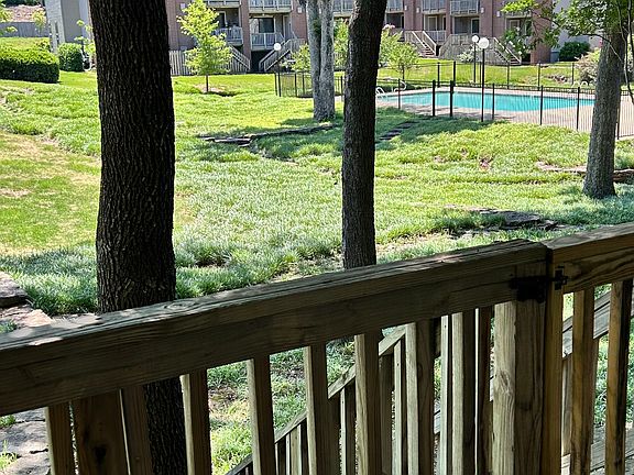 Back Deck extends entire width of condo and has a view of the community pool.