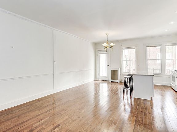 View of the living room and dining area, with the kitchen to the left.