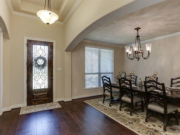 Leaded glass entry door and elegant architectural features throughout.