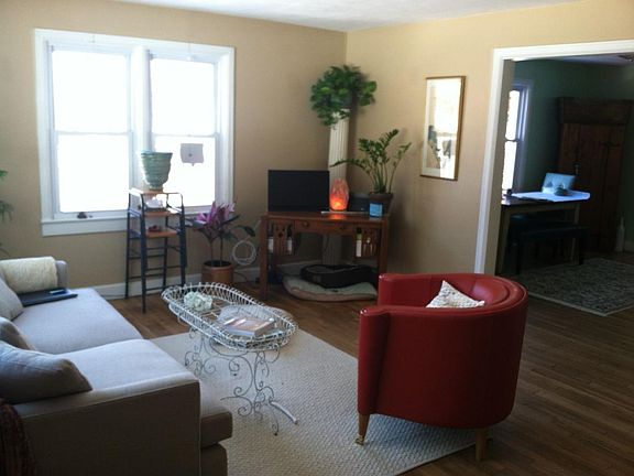 Living Room walls have been painted light gray with charcoal gray accent wall leading into the dining room.
