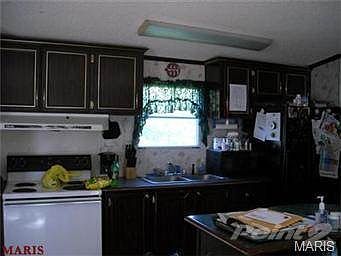 KITCHEN ALSO HAS LARGE ISLAND WITH CABINETS