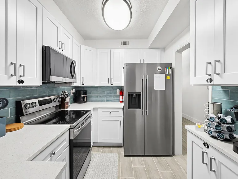 Ample counter space, tile backsplash, and stainless appliances including air fryer