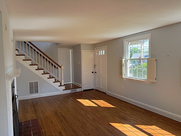 Living Room view and Den and full bath is on other side of staircase on first floor.