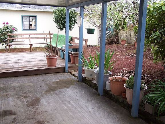 Back yard with nice landscaping and deck.
