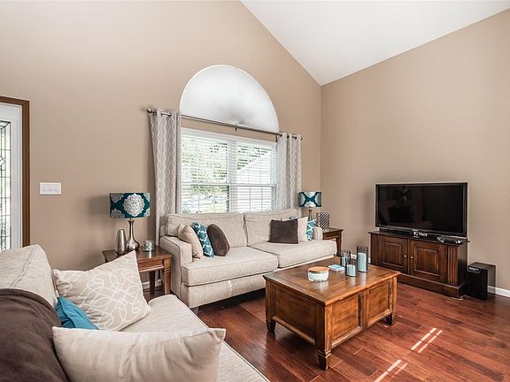 Spacious family room with gleaming hardwood floors.