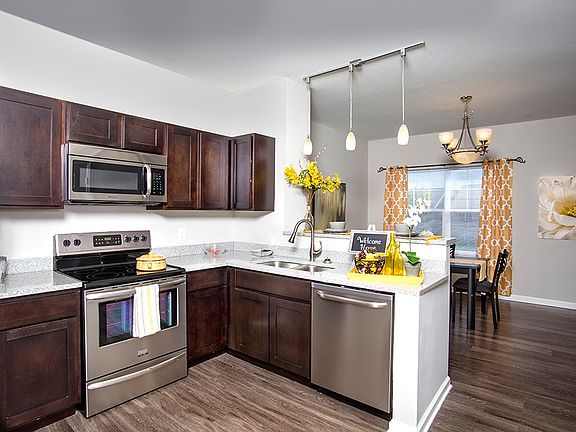 Open concept kitchen with granite and stainless steel applia