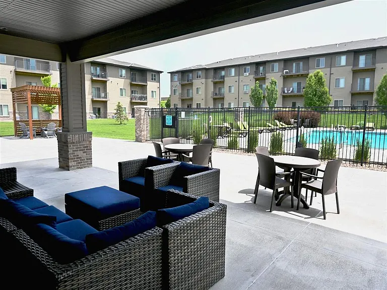 Community outdoor lounge area next to pool at The Sterling Kearney.