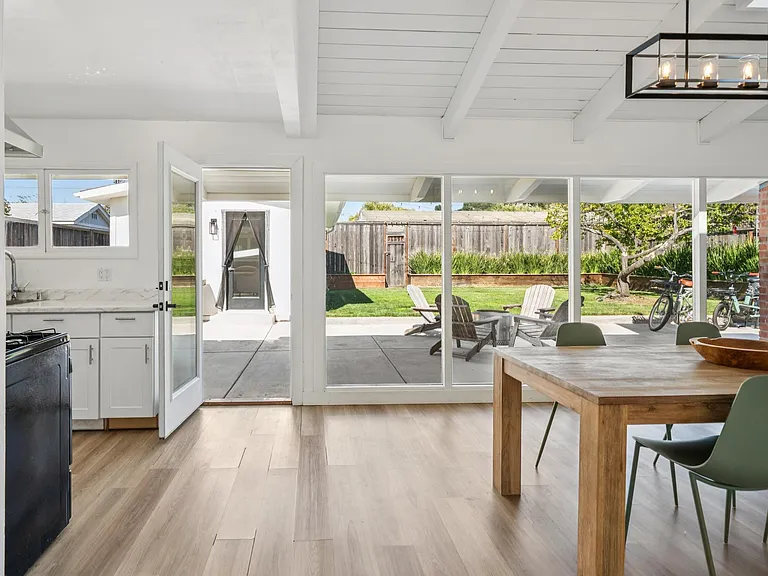 Wall of windows overlooking the private backyard and detached guest studio