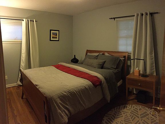 Master bedroom with neutral paint and hard wood floors.