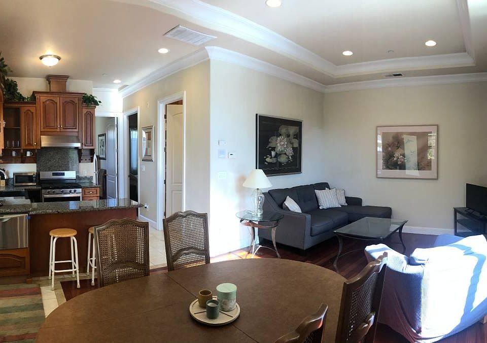 View of the open living room and kitchen from the dining nook