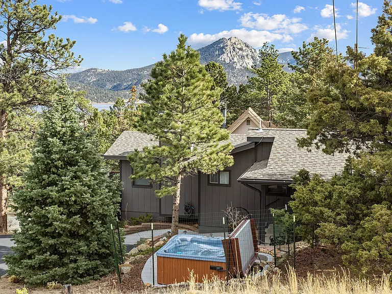 Side of home with hot tub, trees and mountain views!