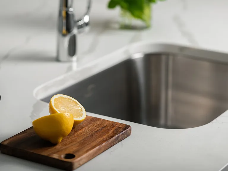 Modern kitchen sink with sleek chrome design, showcasing a stylish and functional space.