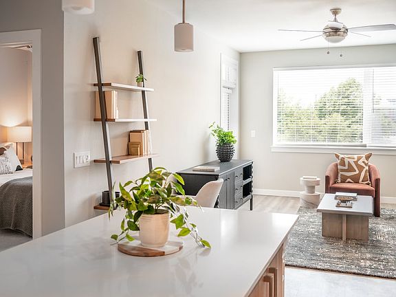 Living area with hard surface flooring and granite kitchen island