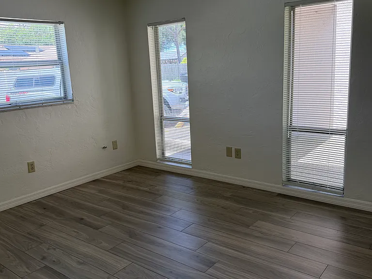 Living room with 3 windows and beautiful tile flooring