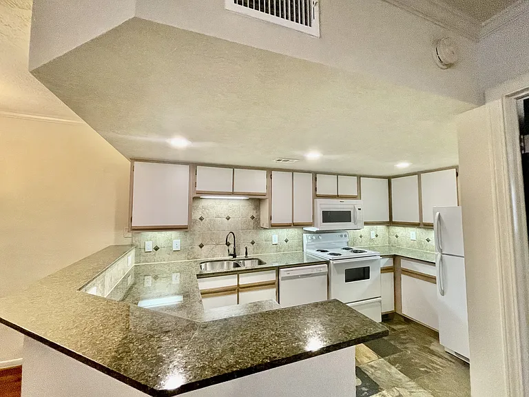 Open kitchen with plenty of counter space and cabinets.